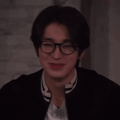 A Close Up Of A Person Wearing Glasses And A Jacket GIF
