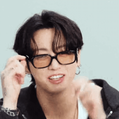 A Close Up Of A Person Wearing Glasses And A Jacket . GIF
