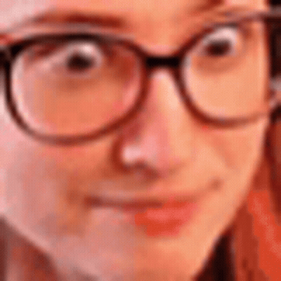 A Close Up Of A Person Wearing Glasses And Making A Funny Face . GIF