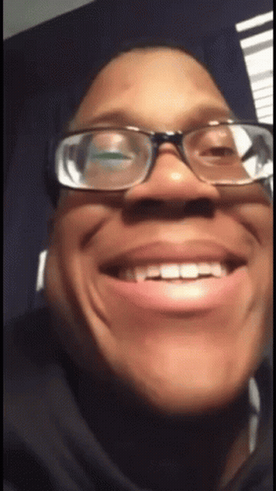 A Close Up Of A Person Wearing Glasses And Making A Funny Face GIF