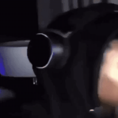 A Close Up Of A Person Wearing Headphones And A Mask . GIF
