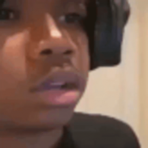 A Close Up Of A Person Wearing Headphones And Looking At The Camera . GIF