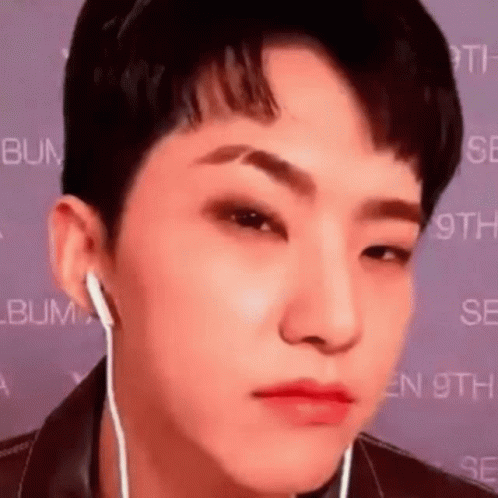 A Close Up Of A Person Wearing Headphones And Making A Face . GIF