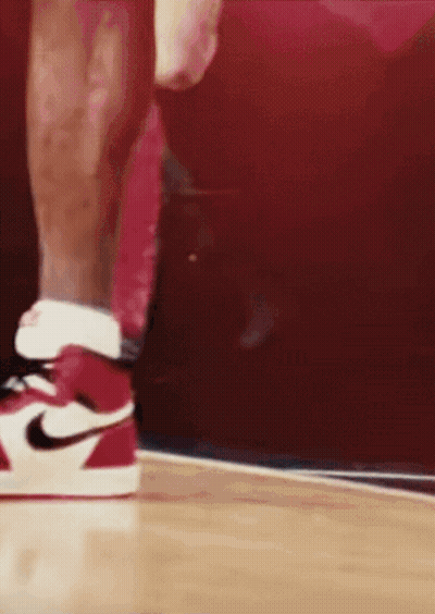 A Close Up Of A Person Wearing Red And White Nike Shoes GIF