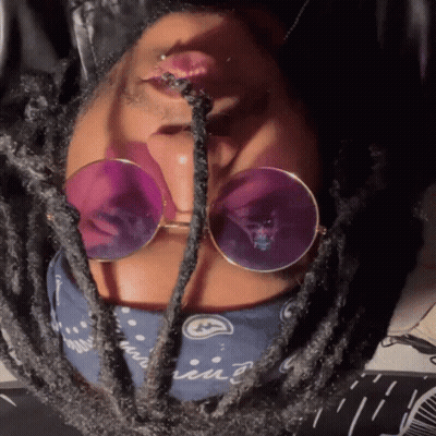 A Close Up Of A Person Wearing Sunglasses And A Bandana That Says ' Iin ' On It GIF