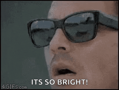 A Close Up Of A Person Wearing Sunglasses With The Words `` It 'S So Bright '' . GIF