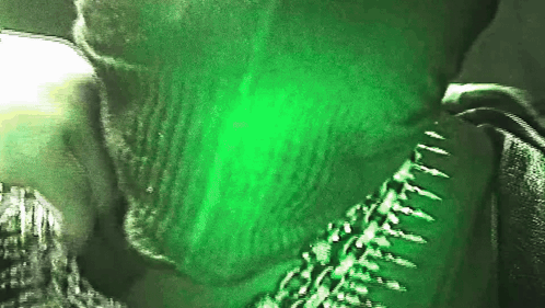 A Close Up Of A Person With A Green Background GIF