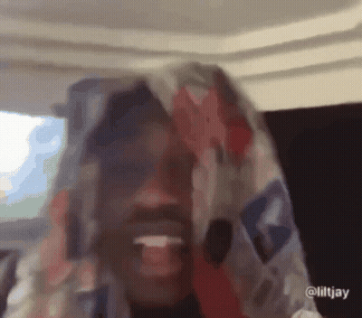 A Close Up Of A Person With A Scarf On Their Head GIF