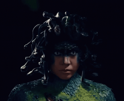A Close Up Of A Person With A Snake Costume GIF
