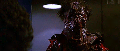 A Close Up Of A Person With Blood On Their Face And A Light Above Them GIF