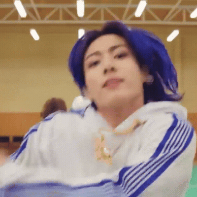 A Close Up Of A Person With Blue Hair Wearing A White And Blue Sweatshirt . GIF