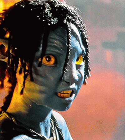 A Close Up Of A Person With Blue Paint On Their Face And Yellow Eyes GIF