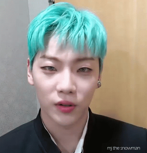 A Close Up Of A Person With Green Hair GIF