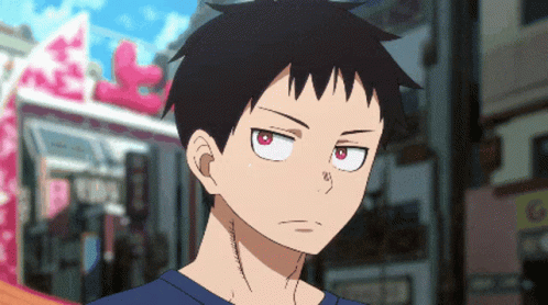 A Close Up Of A Person With Red Eyes And A Blue Shirt GIF