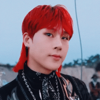 A Close Up Of A Person With Red Hair Wearing A Black Shirt And A Bandana . GIF