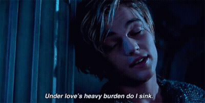 A Close Up Of A Person With The Words Under Love 'S Heavy Burden Do I Sink GIF