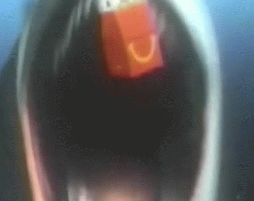 A Close Up Of A Person With Their Mouth Open And A Red Object In It GIF