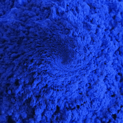 A Close Up Of A Pile Of Blue Powder With A Swirl In The Middle GIF