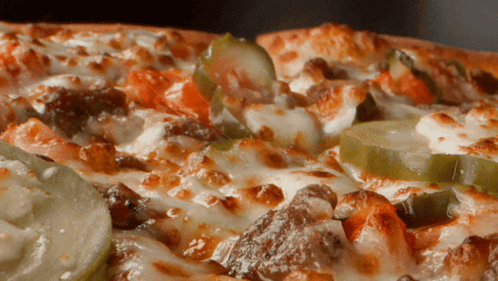 A Close Up Of A Pizza With A Lot Of Toppings GIF