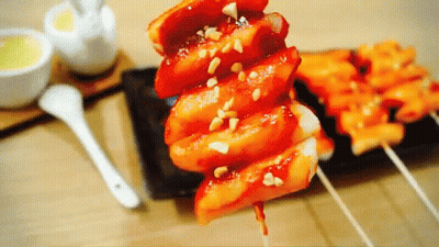 A Close Up Of A Plate Of Food With A Spoon On The Table GIF