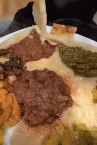 A Close Up Of A Plate Of Food With Meat And Vegetables On It GIF