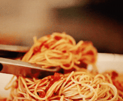 A Close Up Of A Plate Of Spaghetti With Sauce GIF