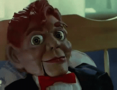 A Close Up Of A Puppet Wearing A Tuxedo And Bow Tie . GIF