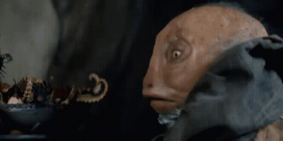 A Close Up Of A Puppet With A Beard Looking At Something GIF