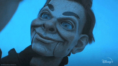 A Close Up Of A Puppet With A Disney Logo In The Background GIF