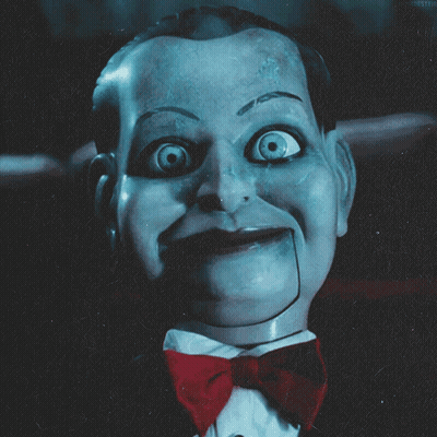 A Close Up Of A Puppet With A Red Bow Tie GIF