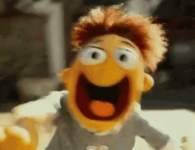 A Close Up Of A Puppet With Its Mouth Open And A Tongue Sticking Out . GIF