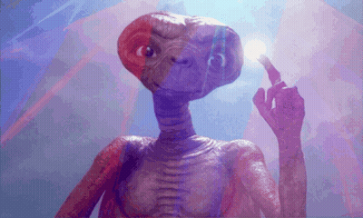 A Close Up Of A Purple Alien Holding A Light Bulb GIF