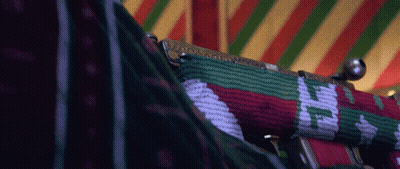 A Close Up Of A Purse With A Red Green And White Pattern On It GIF