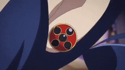 A Close Up Of A Red And Black Circle On A Person 'S Shoulder . GIF