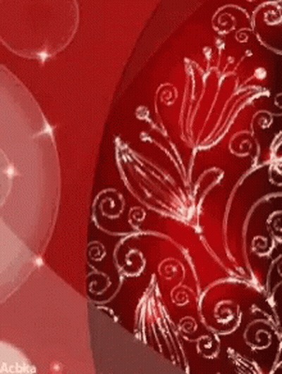 A Close Up Of A Red Background With Flowers And Swirls On It GIF