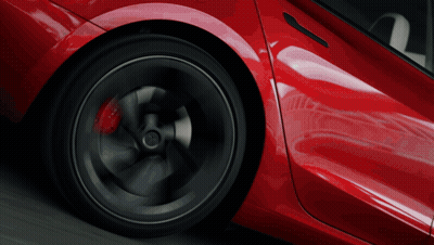 A Close Up Of A Red Car 'S Wheel With A Black Rim GIF