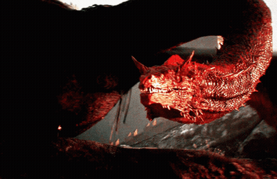 A Close Up Of A Red Dragon With Sharp Teeth Looking At The Camera GIF