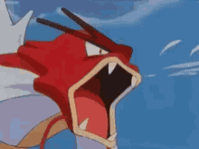 A Close Up Of A Red Pokemon With Its Mouth Open . GIF