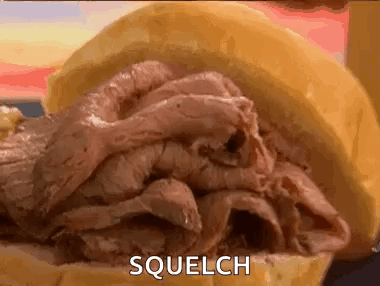 A Close Up Of A Roast Beef Sandwich On A Bun With The Word Squelch Written On It . GIF