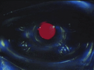 A Close Up Of A Robot Eye With A Red Center GIF