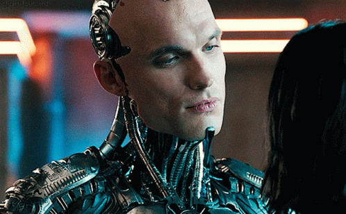 A Close Up Of A Robot Looking At A Woman 'S Face With A Caption That Says ' Stark Beyond ' GIF