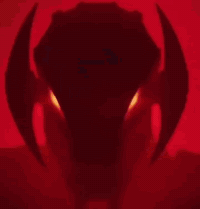 A Close Up Of A Robot 'S Head With Red Eyes . GIF