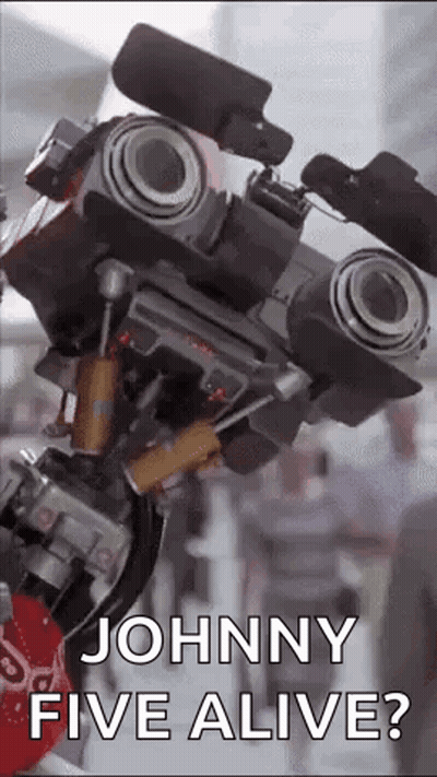 A Close Up Of A Robot That Says `` Johnny Five Alive '' . GIF