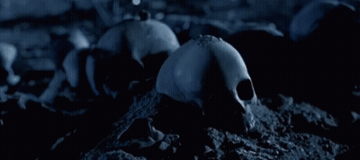 A Close Up Of A Robot With A Gun And A Flame In The Background GIF