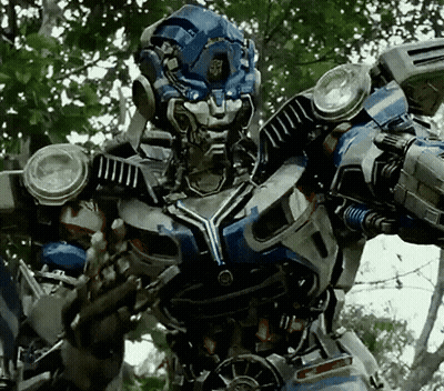 A Close Up Of A Robot With A Helmet On Standing In A Forest . GIF