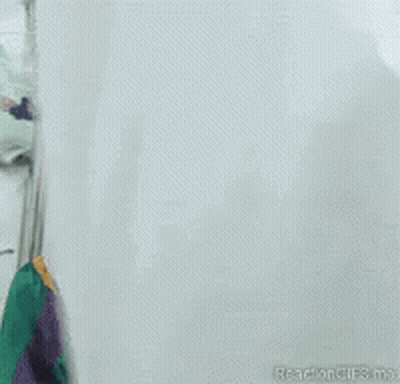 A Close Up Of A Scary Clown With A Red Hat GIF