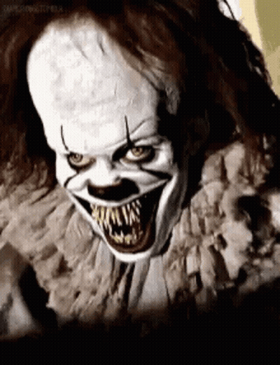 A Close Up Of A Scary Clown With Big Teeth . GIF