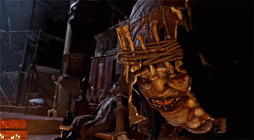 A Close Up Of A Scary Looking Monster With A Rope Around His Head . GIF
