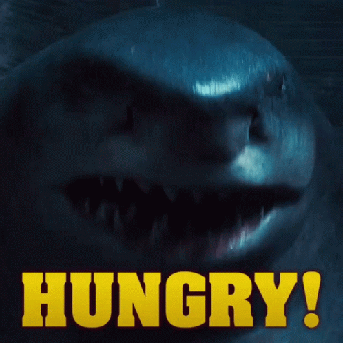 A Close Up Of A Shark With The Words Hungry In Yellow GIF