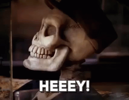 A Close Up Of A Skeleton With The Words Heeey In Front Of It . GIF